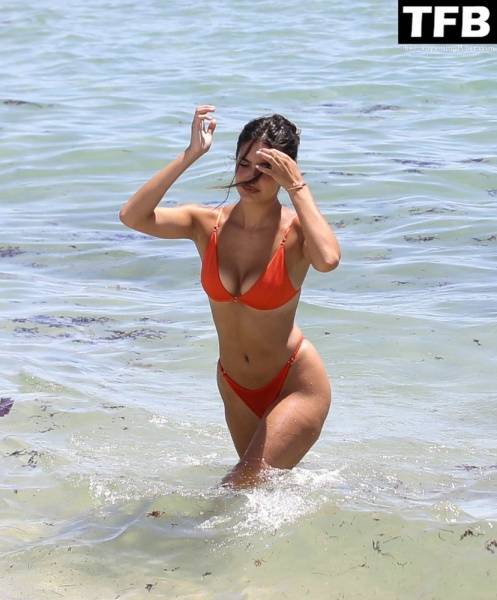 Tao Wickrath Stuns in Small Orange Bikini on the Beach in Miami - county Miami on dailyfans.net